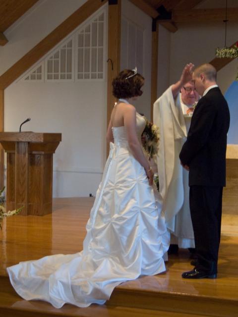 Fr. Tougas blessing Mark and Michelle