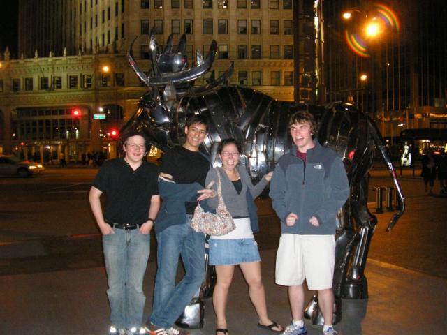 Colin, Christophe, Julia, and Ronan are thrilled looking at the moose over by the river