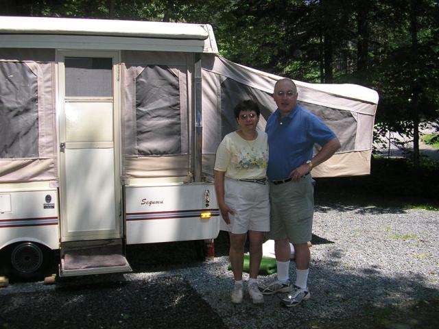 Mom and Dad in front of the camper