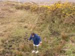 Anne watches her step while geocaching.