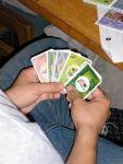 Chris holding his resource cards...from left to right: brick, wood, rock, sheep, and paper.