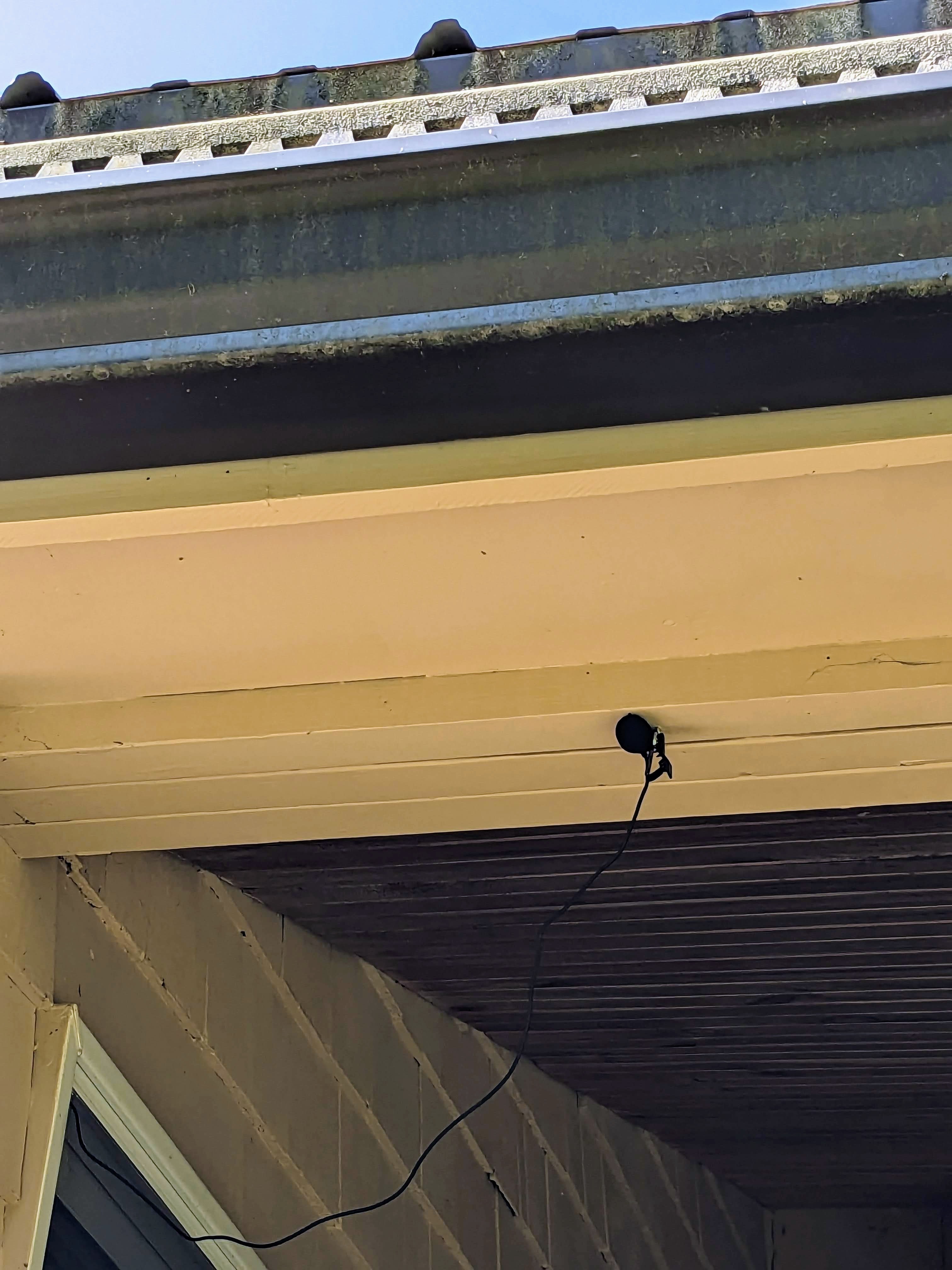 Microphone mounted under the eaves.